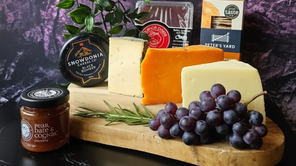 Curated box of pregnancy-safe hard cheeses on a wooden board, gourmet foodie gift for pregnant friend.