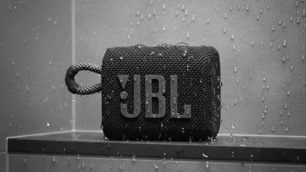 The waterproof JBL Go 3 Bluetooth speaker in a modern shower, a fun and practical housewarming gift for him.