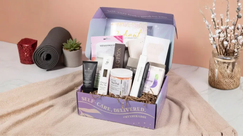 A TheraBox self-care subscription box, shown open on a clean surface, displaying its contents of full-sized wellness goodies and skincare products, as a thoughtful gift for mom.